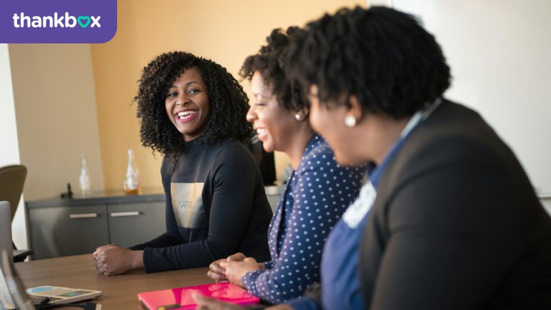 Smiling women sitting at a table