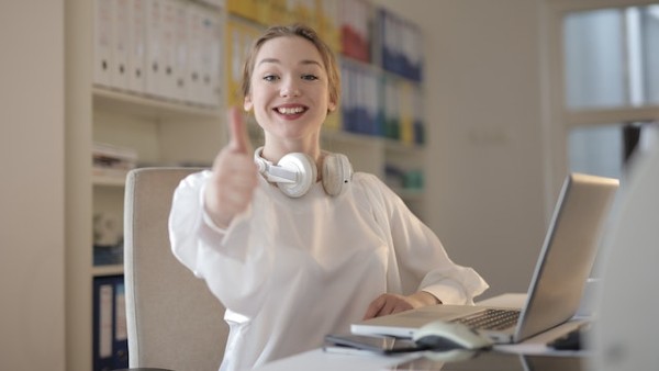 Woman Wearing White Top While Doing Thumbs Up
