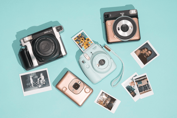 Collection of Fujix Instax cameras showing many different models and captured photos.