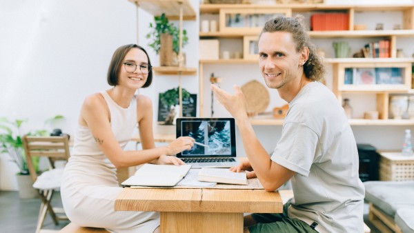 A man and a woman sitting at a table and smiling