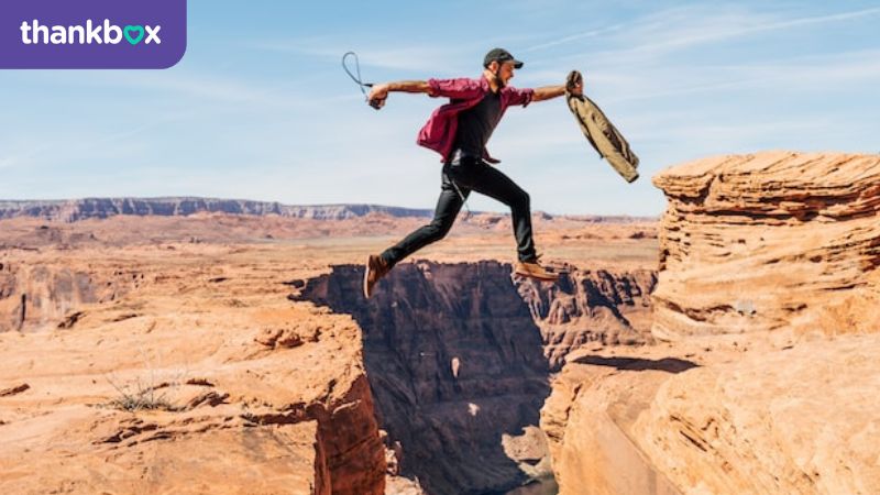Man jumping over crevice in Grand Canyon