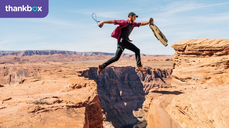 Man jumping over crevice in Grand Canyon