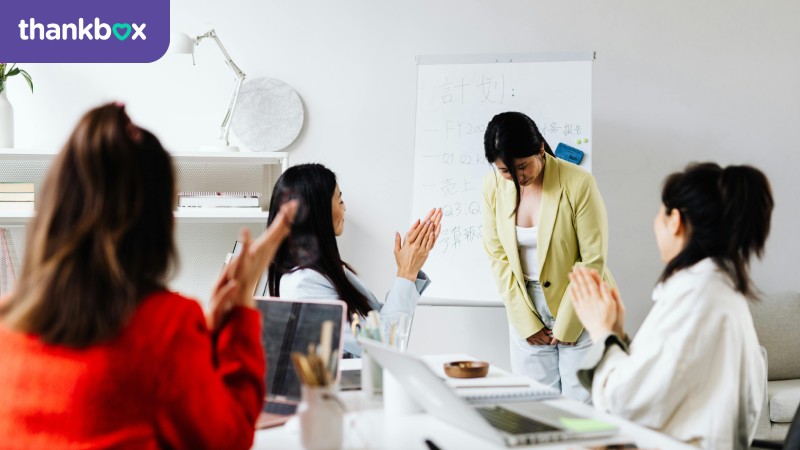 A Woman being Praised after a Presentation
