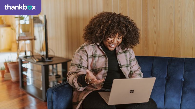 Remote working - woman sat on sofa with laptop