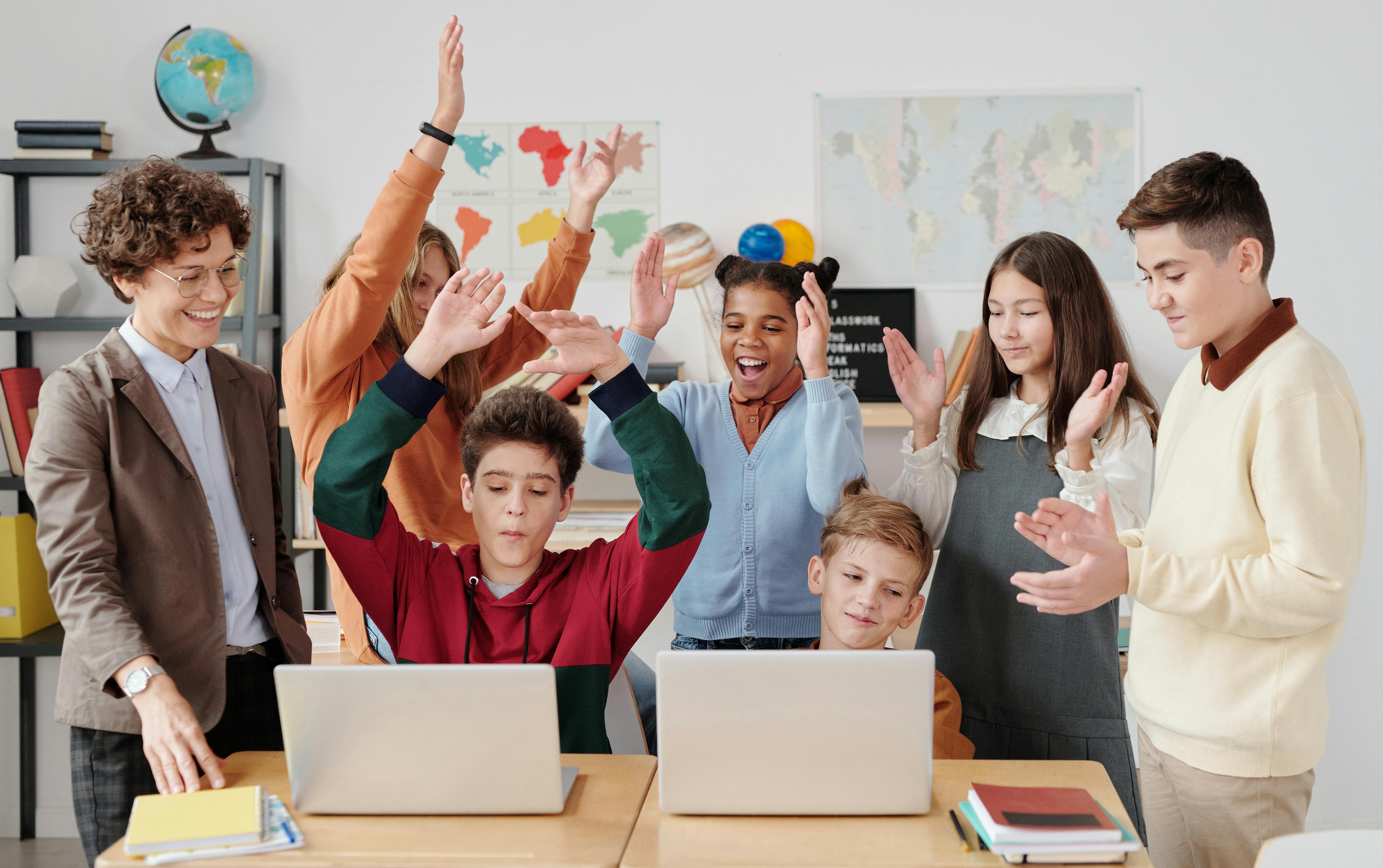Children Clapping Together in a Classroom