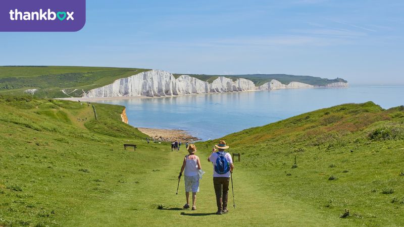 Retired couple walking on the chalk cliffs