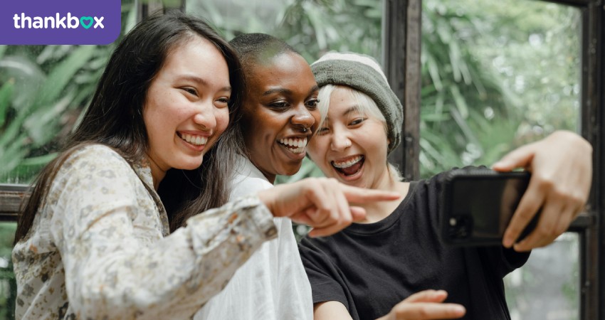 Female friends laughing while taking a selfie