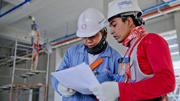 Two men wearing helmets