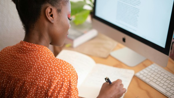 Woman writing on her notebook