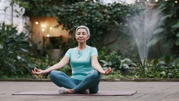 An elderly woman meditating