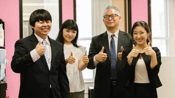 Asian team giving thumbs up