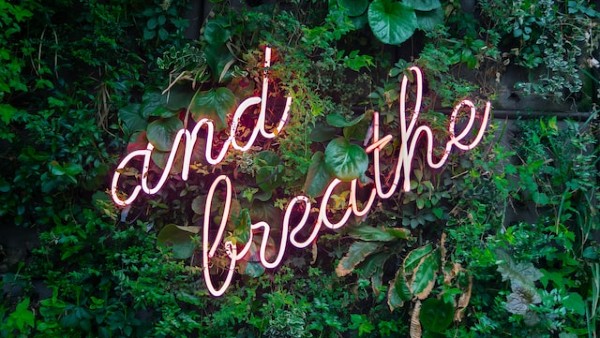 'and breathe' neon sign