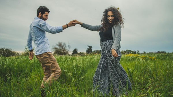 Man and woman dancing on a grass field