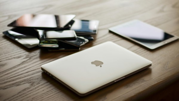 Macbook and other devices on a desk