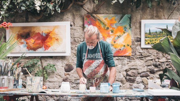 A man painting on a table