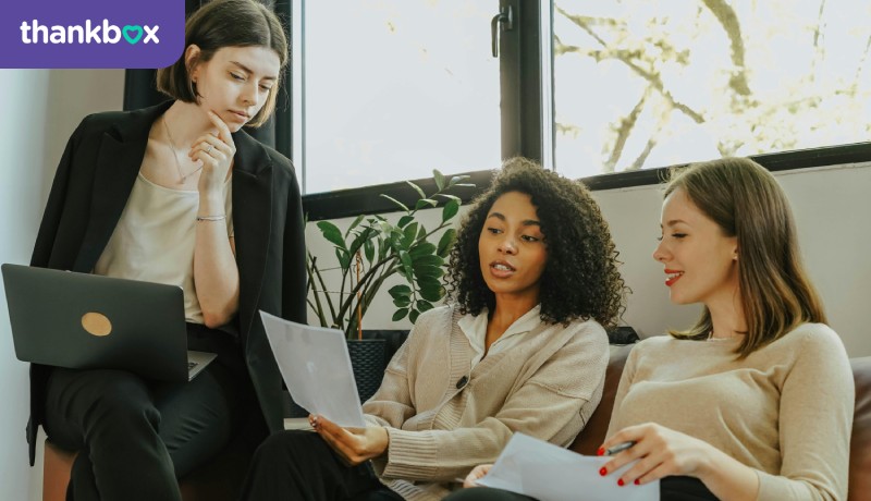 Women Sitting on a Sofa While Talking Business
