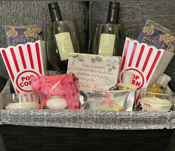 An image of a sample date night gift box incl. popcorn, wine and gorgeous sweet things