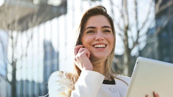 Woman in white blazer talking on the phone