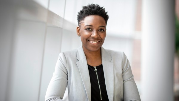 Smiling woman wearing gray suit