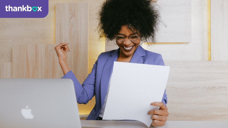 Smiling woman holding a document