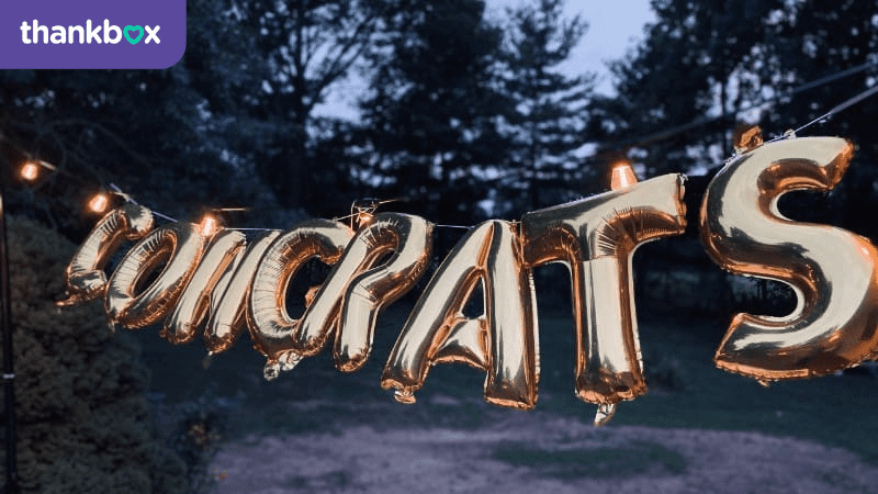 An image of congrats spelled out with gold balloons