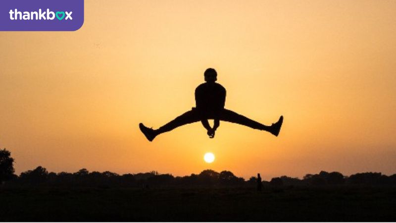 An image of someone in total balance at sunset - wellbeing