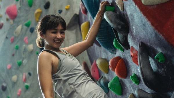 Woman climbing a wall in the gym