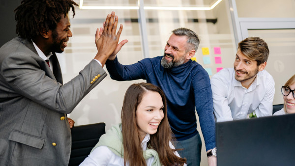 Men doing high five at the office