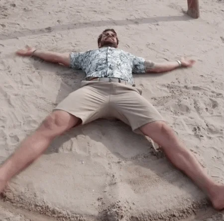 GIF of guy doing horizontal star jump saying - Life's a beach