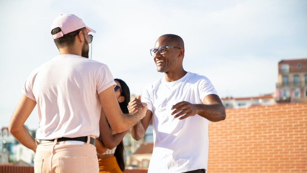 Cheerful men shaking hands