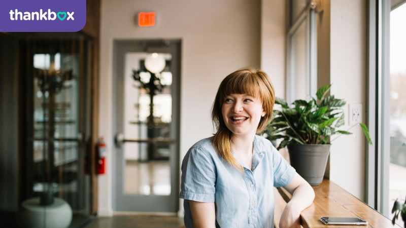 Smiling woman sitting by a window