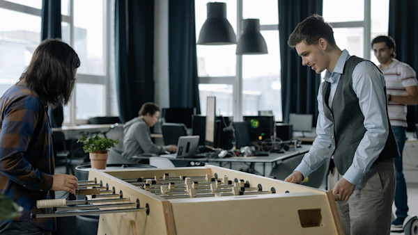 Employees Playing Foosball in Office