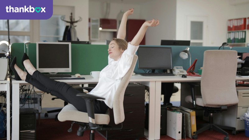 Female office worker relaxing with her feet on a table