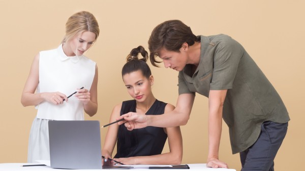 Colleagues looking at a laptop