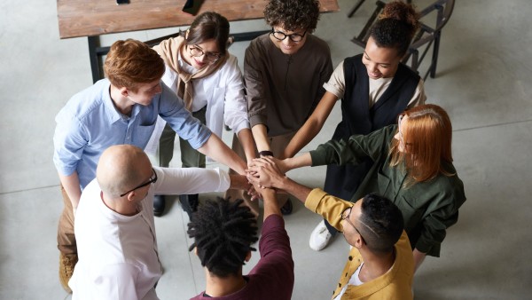 A group of people holding each other's hands 