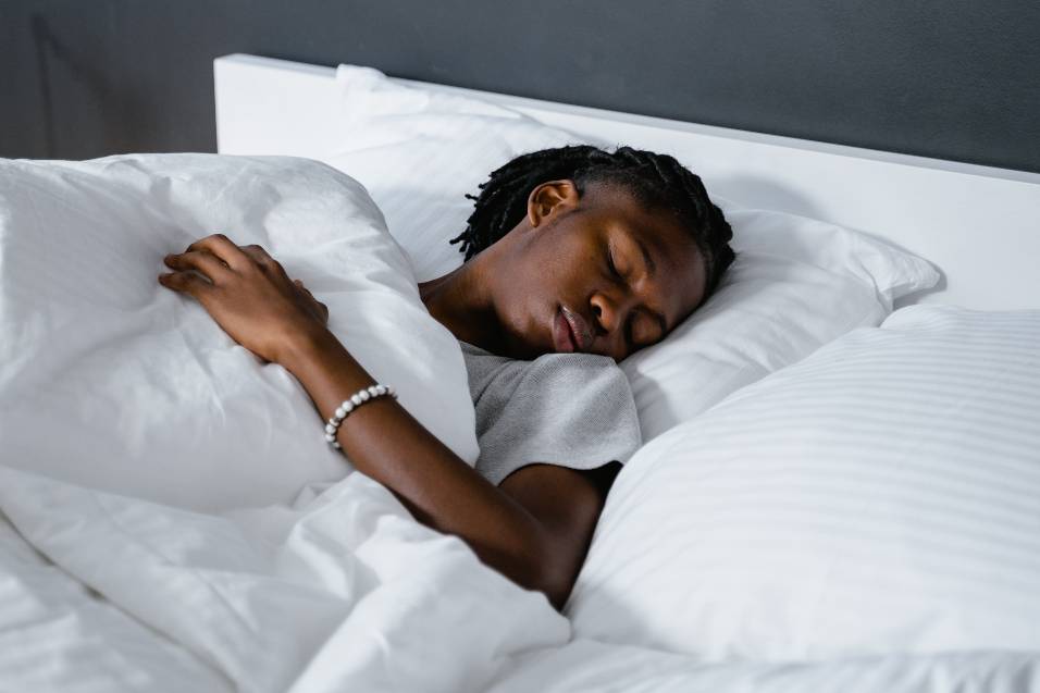 An image of a lady in a state of blissful sleep with a memory foam pillow