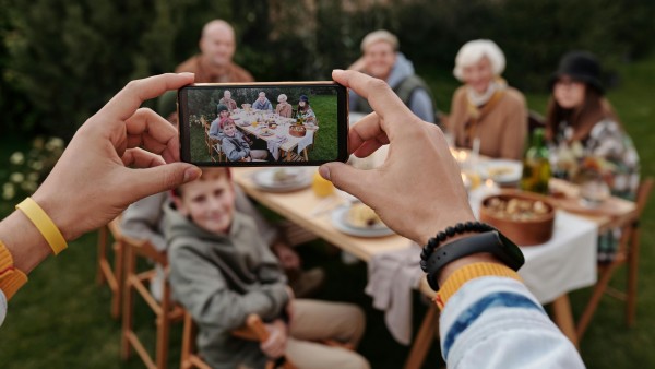 Person taking a photo of a family dinner