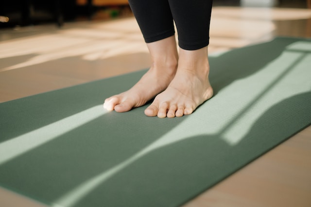 Person standing on yoga mat