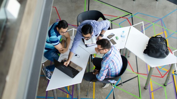 Top-view photo of three men in an office