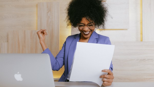 Smiling woman holding a document