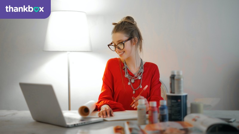 Woman in red long-sleeve shirt working from home