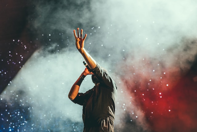 Man on stage in t-shirt singing