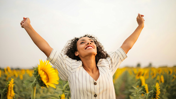 Woman Standing On Sunflower Field