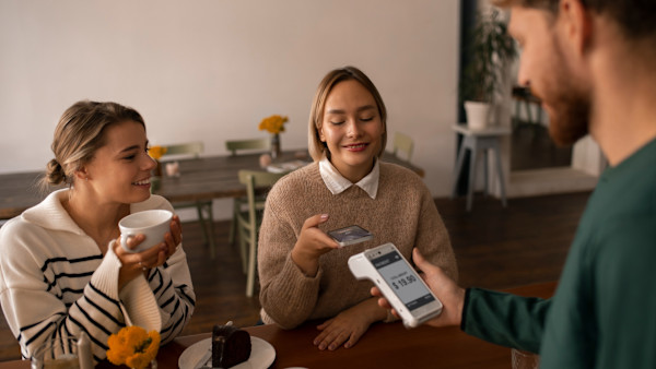 Person paying with a card at a restaurant