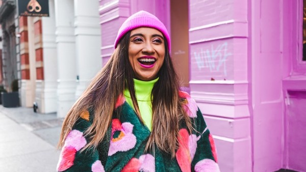 woman in white blue and red sweater wearing pink knit cap