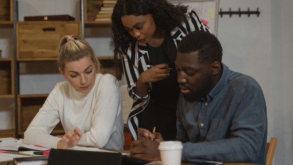 Woman looking at her colleagues' work