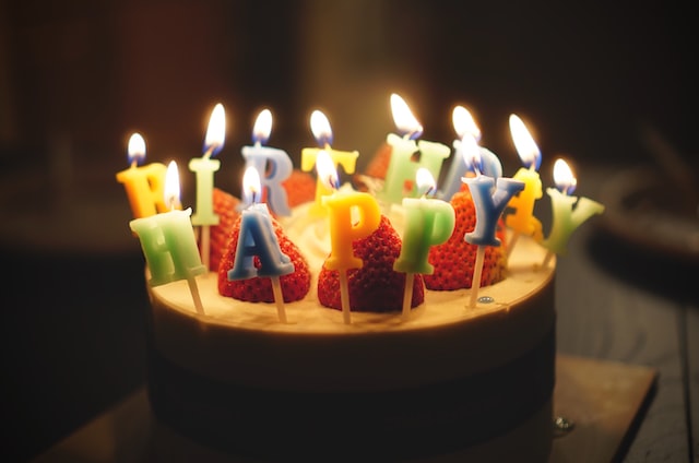 A cake with candles spelling 'Happy Birthday'