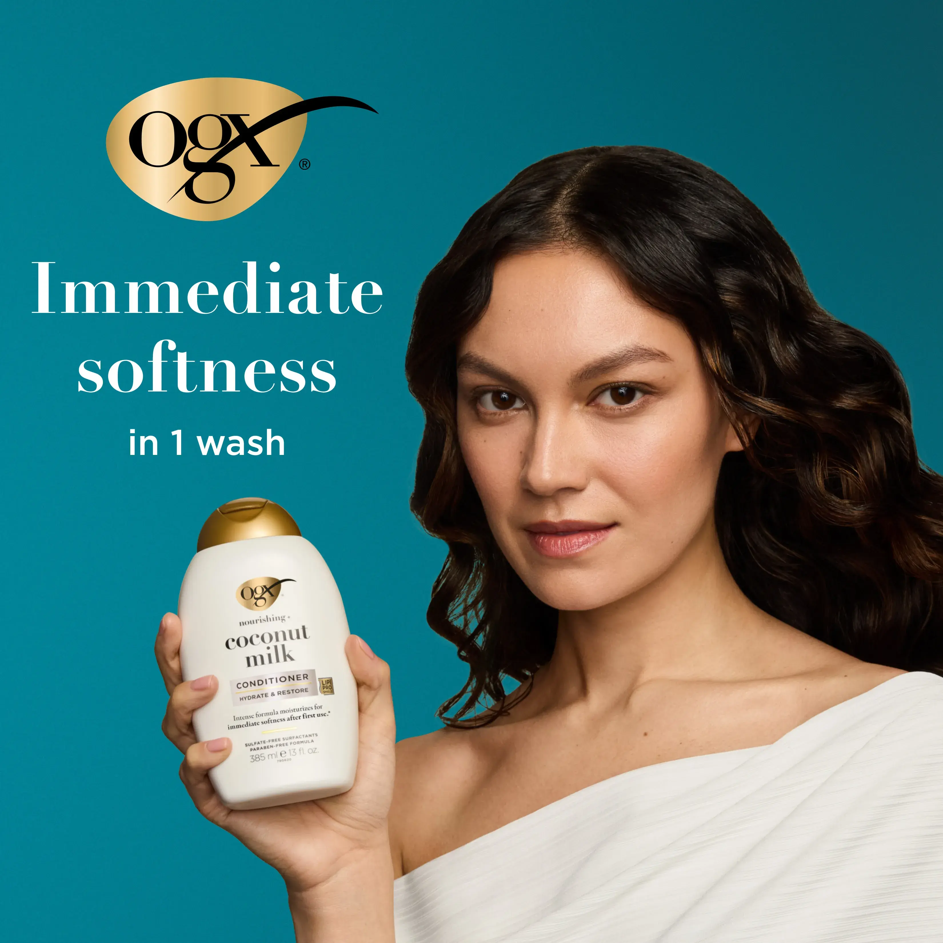 Woman holding Coconut Milk Conditioner. immediate softness in 1 wash