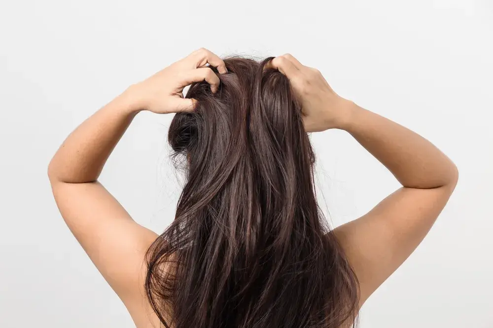 Woman with her hands in her hair before trying the simple solutions explained in the article