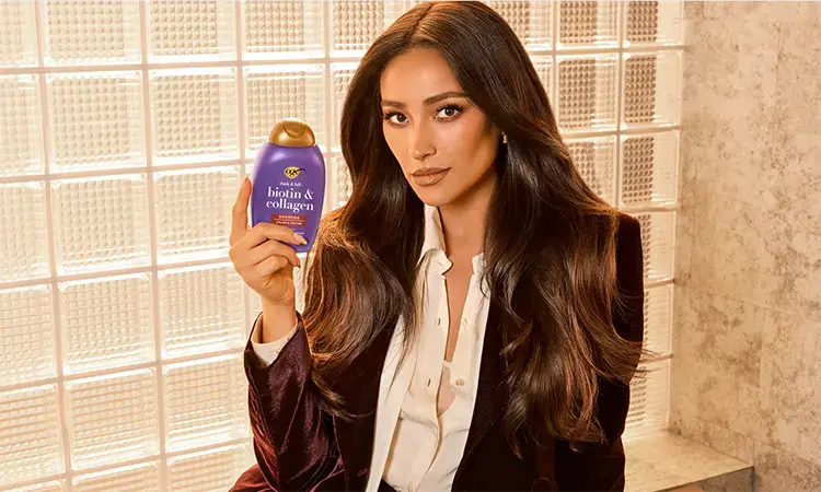 Image Displaying Shay Mitchell holding Biotin and Collagen Shampoo